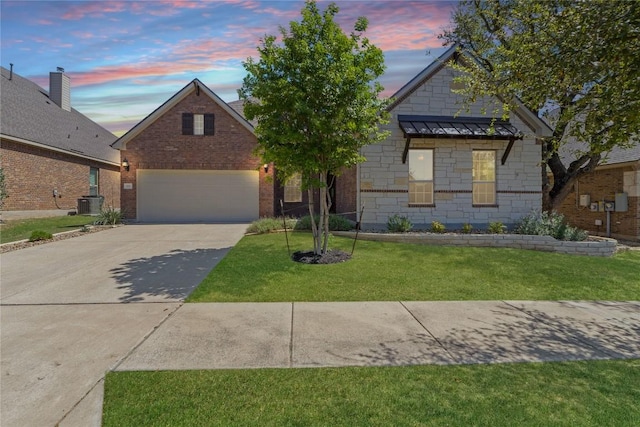 118 Bluehaw Dr, Georgetown, TX 78628 - view of front of home featuring driveway, a standing seam roof, a lawn, and central AC unit