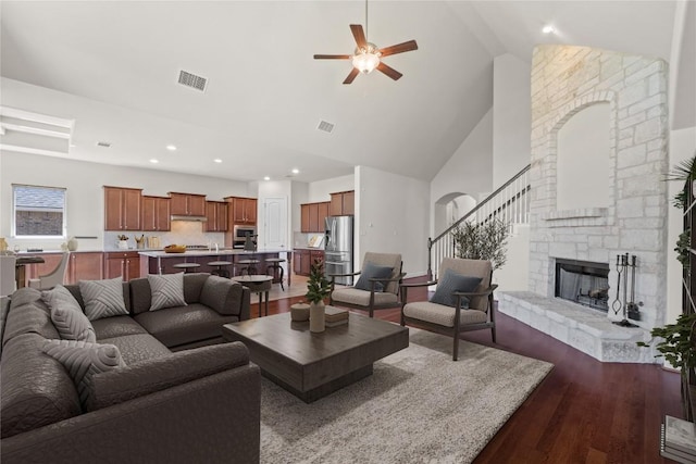 118 Bluehaw Dr, Georgetown, TX 78628 - living area featuring high vaulted ceiling, a ceiling fan, dark wood-style floors, a stone fireplace, and recessed lighting