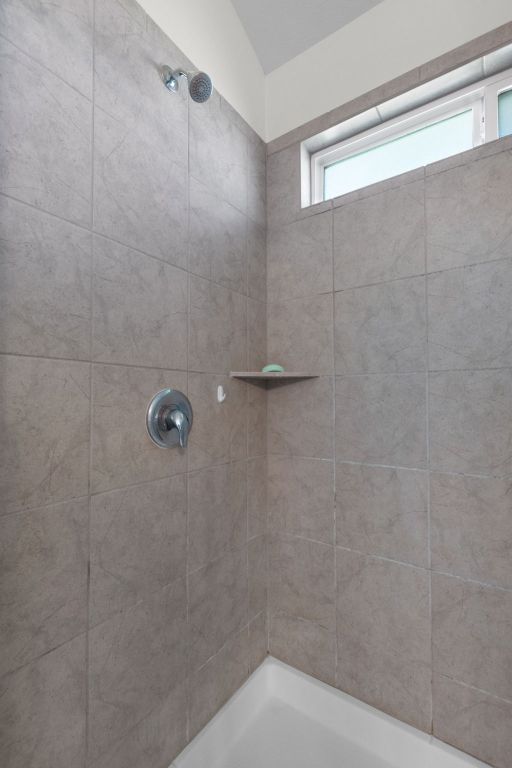 bathroom with tiled shower
