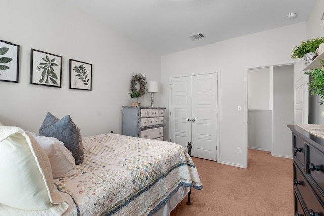bedroom with visible vents, baseboards, a closet, and light carpet