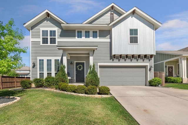 view of front of home featuring an attached garage, concrete driveway, a front yard, and fence