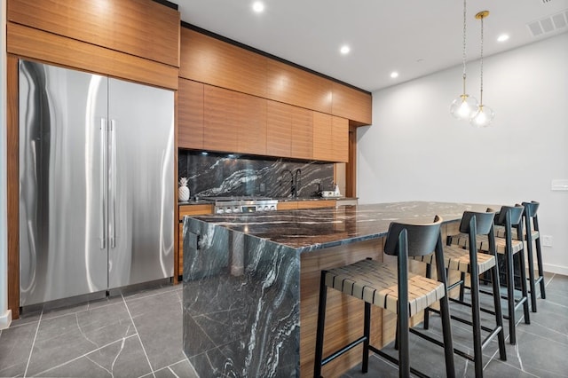 3500 Cactus Wren Way, Austin, TX 78746 - kitchen with stainless steel fridge, tasteful backsplash, tile patterned flooring, a breakfast bar area, and recessed lighting