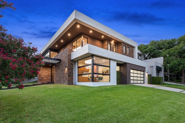 3500 Cactus Wren Way, Austin, TX 78746 - view of front of home featuring a balcony, concrete driveway, a front lawn, and stucco siding