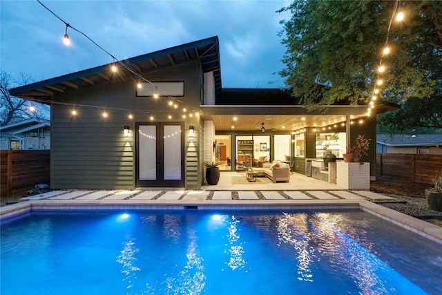 7700 Tisdale Dr, Austin, TX 78757 - rear view of house with fence, french doors, area for grilling, and a fenced in pool