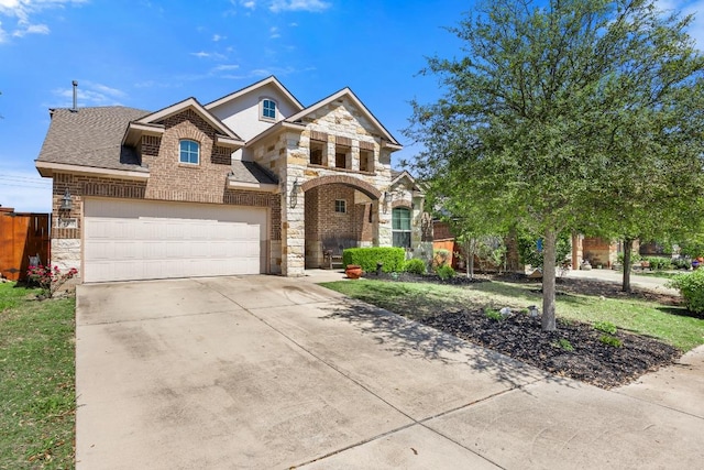 view of front facade featuring stone siding, fence, concrete driveway, and brick siding