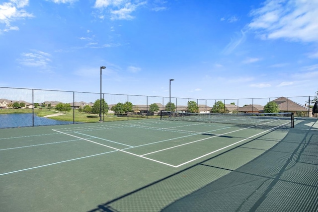 view of tennis court with fence