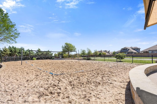 view of property's community with fence and volleyball court