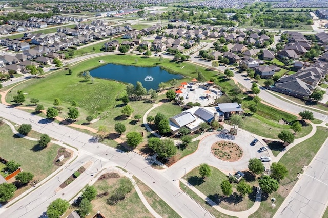 aerial view of property and surrounding area featuring a nearby body of water and nearby suburban area