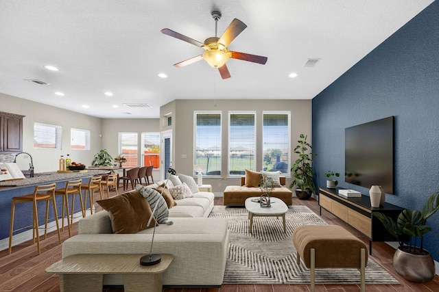 living area featuring wood finished floors, recessed lighting, and a ceiling fan