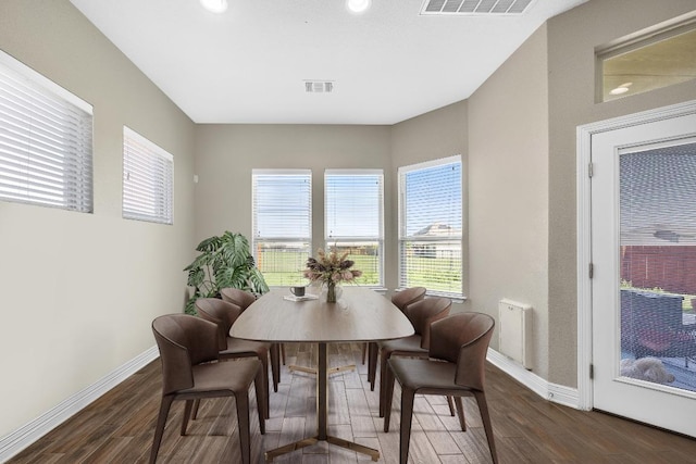dining room with wood finished floors, baseboards, plenty of natural light, and recessed lighting
