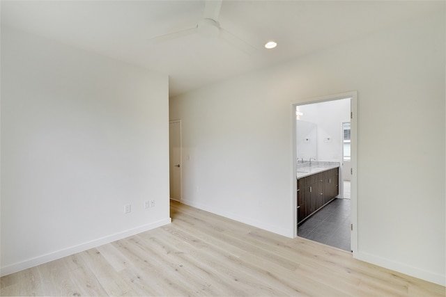 2312 Enfield Rd Unit 2, Austin, TX 78703 - empty room with wood finished floors, ceiling fan, baseboards, and a sink
