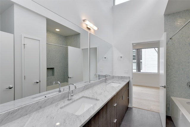2312 Enfield Rd Unit 2, Austin, TX 78703 - bathroom with a tub to relax in, double vanity, tile patterned floors, a shower, and a high ceiling