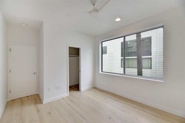 2312 Enfield Rd Unit 2, Austin, TX 78703 - unfurnished bedroom with wood finished floors, baseboards, a closet, a spacious closet, and ceiling fan