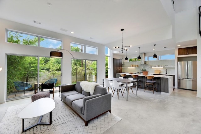 2312 Enfield Rd Unit 2, Austin, TX 78703 - living area with healthy amount of natural light, finished concrete flooring, recessed lighting, and a chandelier