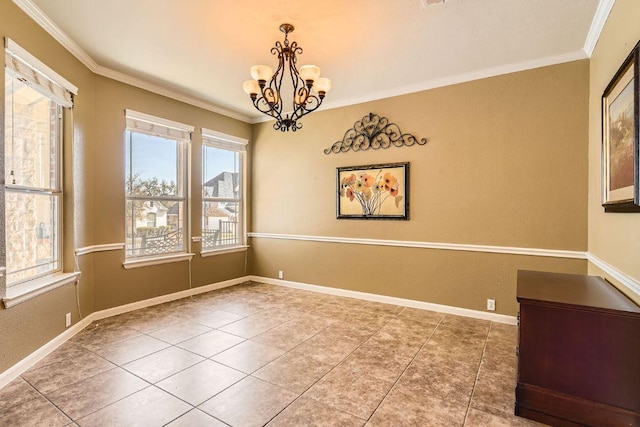 spare room with an inviting chandelier, tile patterned floors, baseboards, and ornamental molding