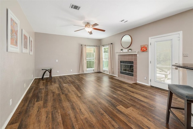 2204 Rick Whinery Dr, Austin, TX 78728 - unfurnished living room with wood finished floors, a ceiling fan, and a tiled fireplace