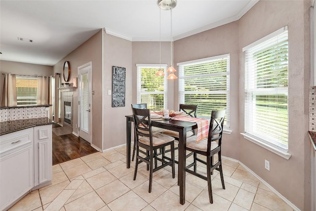 2204 Rick Whinery Dr, Austin, TX 78728 - dining space featuring healthy amount of natural light, light tile patterned flooring, and crown molding
