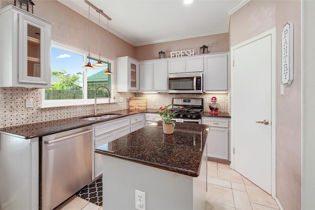 2204 Rick Whinery Dr, Austin, TX 78728 - kitchen featuring appliances with stainless steel finishes, a sink, tasteful backsplash, white cabinetry, and glass insert cabinets