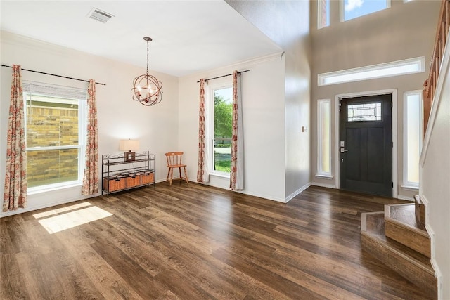 2204 Rick Whinery Dr, Austin, TX 78728 - foyer entrance with a chandelier, dark wood-type flooring, and baseboards