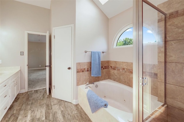 2204 Rick Whinery Dr, Austin, TX 78728 - full bathroom with a whirlpool tub, vanity, a shower stall, and lofted ceiling