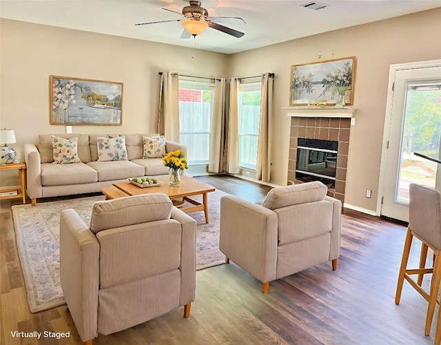 2204 Rick Whinery Dr, Austin, TX 78728 - living area with a ceiling fan, wood finished floors, and a tiled fireplace