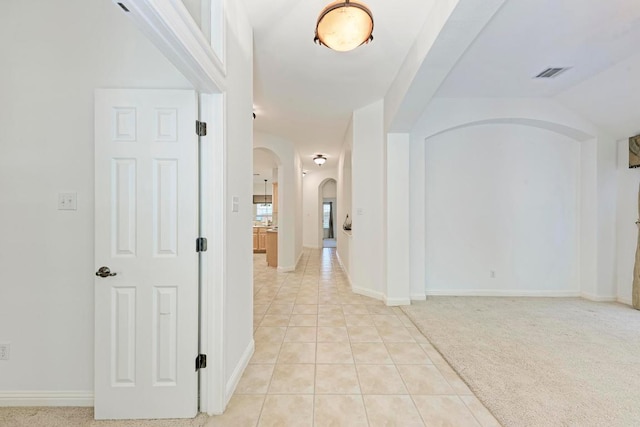 2709 Quiet Moon Trl, Cedar Park, TX 78613 - corridor featuring arched walkways, light tile patterned floors, and baseboards