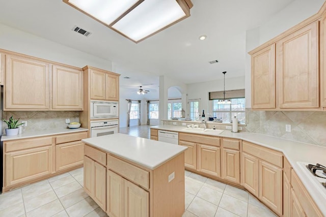 2709 Quiet Moon Trl, Cedar Park, TX 78613 - kitchen featuring light brown cabinets, white appliances, light tile patterned flooring, plenty of natural light, and recessed lighting