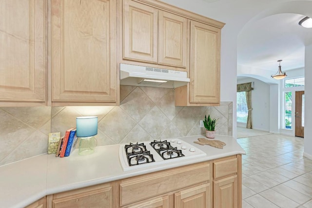 2709 Quiet Moon Trl, Cedar Park, TX 78613 - kitchen featuring arched walkways, light brown cabinets, under cabinet range hood, and white gas cooktop