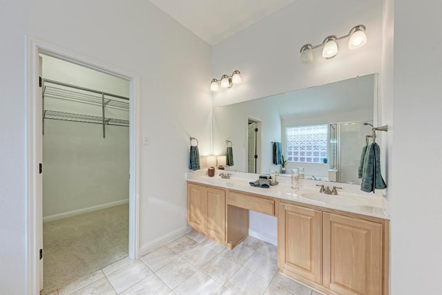 2709 Quiet Moon Trl, Cedar Park, TX 78613 - full bathroom featuring a shower stall, a walk in closet, double vanity, and baseboards