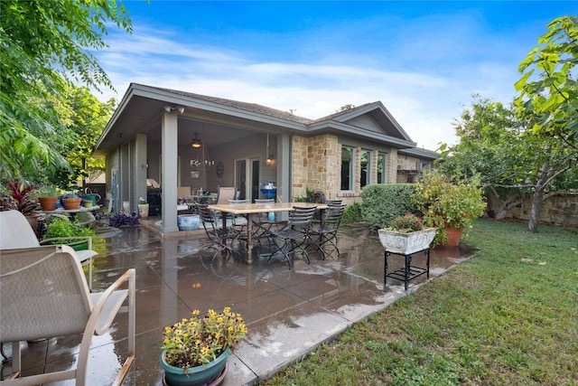 20000 Columbus Ln, Lago Vista, TX 78645 - back of house with a patio area, stone siding, a lawn, and outdoor dining space