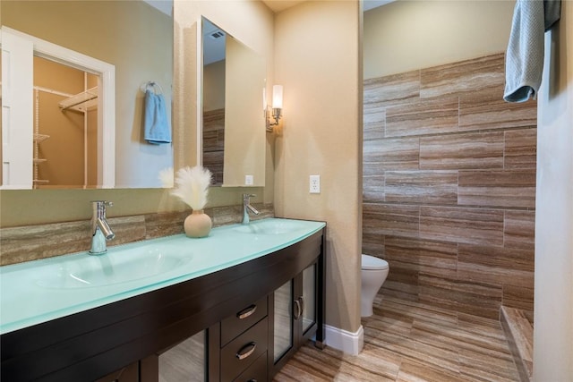 20000 Columbus Ln, Lago Vista, TX 78645 - full bathroom with double vanity, tiled shower, and tile walls