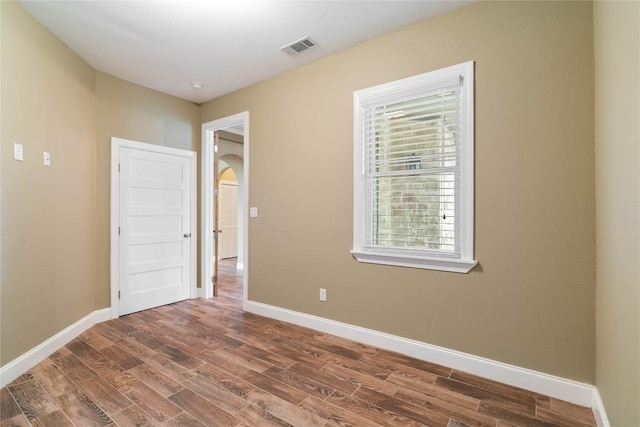 20000 Columbus Ln, Lago Vista, TX 78645 - unfurnished room featuring wood finished floors, healthy amount of natural light, and arched walkways