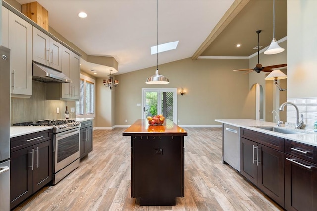20000 Columbus Ln, Lago Vista, TX 78645 - kitchen featuring stainless steel appliances, under cabinet range hood, a kitchen island, tasteful backsplash, and recessed lighting