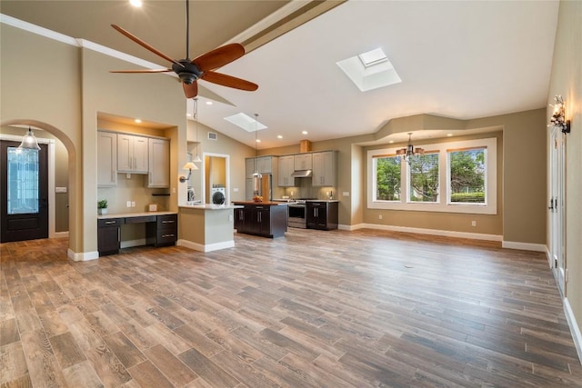 20000 Columbus Ln, Lago Vista, TX 78645 - kitchen with a skylight, stainless steel range with gas cooktop, open floor plan, vaulted ceiling, and a ceiling fan