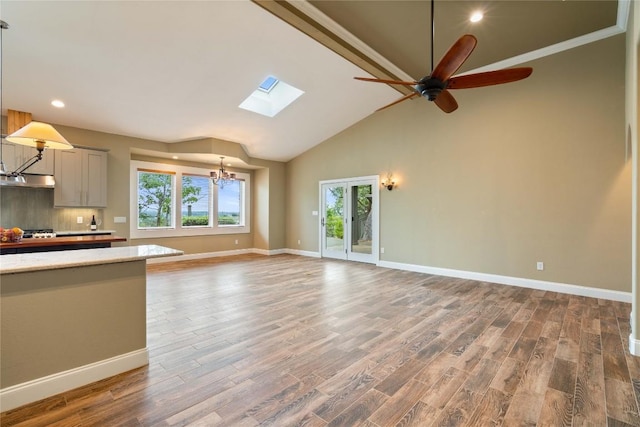 20000 Columbus Ln, Lago Vista, TX 78645 - unfurnished living room with a ceiling fan, wood finished floors, a skylight, recessed lighting, and a chandelier