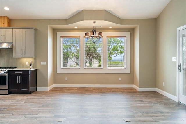 20000 Columbus Ln, Lago Vista, TX 78645 - kitchen with stainless steel gas stove, range hood, a chandelier, recessed lighting, and light wood-style flooring