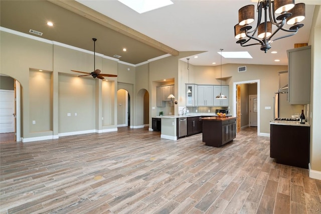 20000 Columbus Ln, Lago Vista, TX 78645 - kitchen featuring arched walkways, stainless steel appliances, high vaulted ceiling, open floor plan, and a center island
