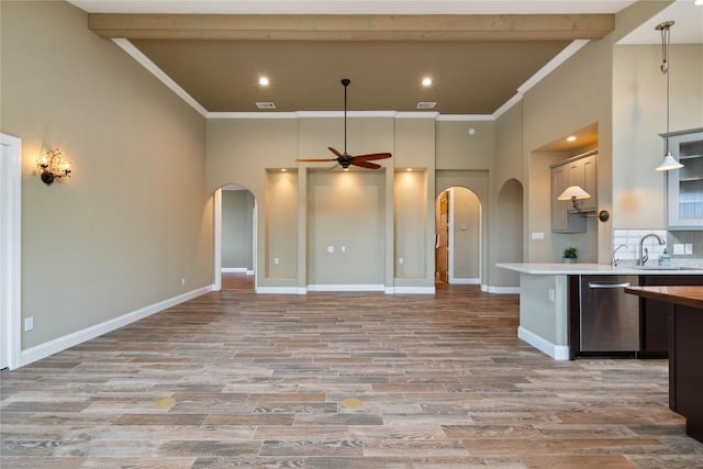 20000 Columbus Ln, Lago Vista, TX 78645 - kitchen featuring stainless steel dishwasher, arched walkways, a ceiling fan, a towering ceiling, and light countertops