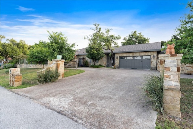 20000 Columbus Ln, Lago Vista, TX 78645 - view of front of house with an attached garage, driveway, stone siding, and a shingled roof