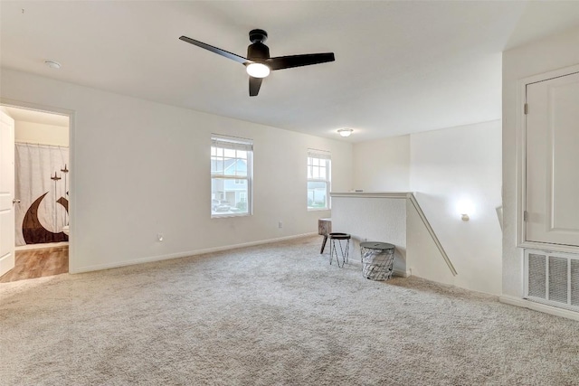 14209 Jeannette Rankin Rd, Manor, TX 78653 - unfurnished living room with carpet floors, a ceiling fan, and baseboards