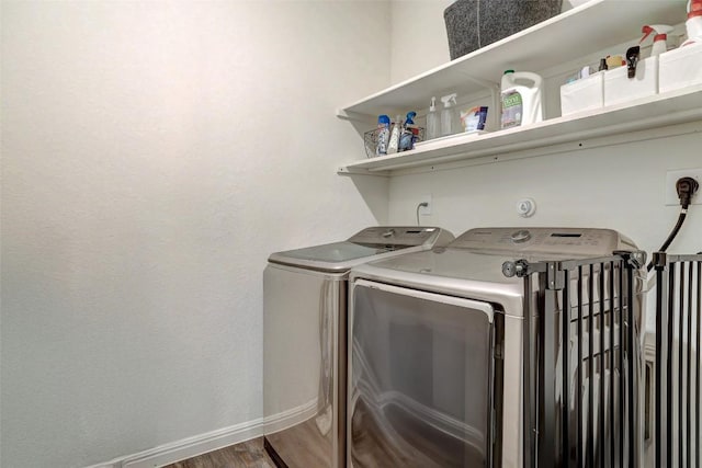 14209 Jeannette Rankin Rd, Manor, TX 78653 - laundry area with washing machine and clothes dryer, wood finished floors, and baseboards