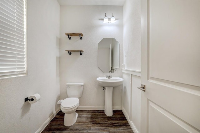 14209 Jeannette Rankin Rd, Manor, TX 78653 - half bathroom with toilet, wood finished floors, a sink, and baseboards