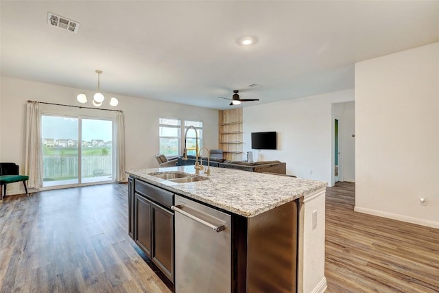 14209 Jeannette Rankin Rd, Manor, TX 78653 - kitchen with a sink, open floor plan, wood finished floors, dishwasher, and baseboards