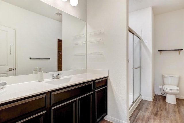 14209 Jeannette Rankin Rd, Manor, TX 78653 - bathroom featuring a shower stall, wood finished floors, vanity, toilet, and baseboards
