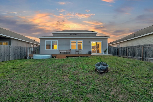 14209 Jeannette Rankin Rd, Manor, TX 78653 - rear view of house with a deck and an outdoor fire pit
