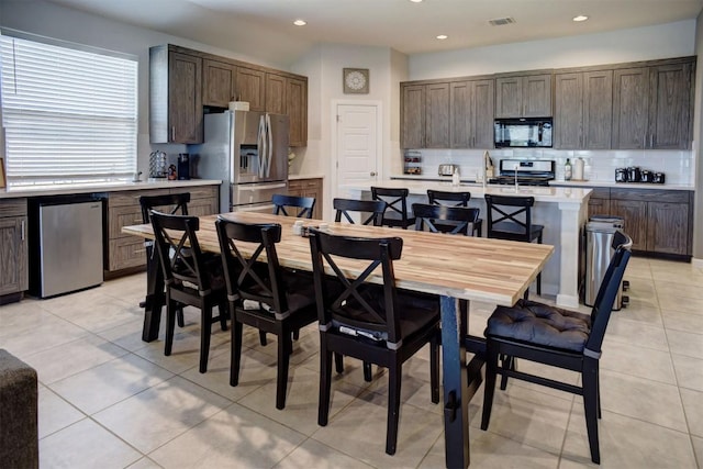 dining space featuring light tile patterned floors, visible vents, and recessed lighting