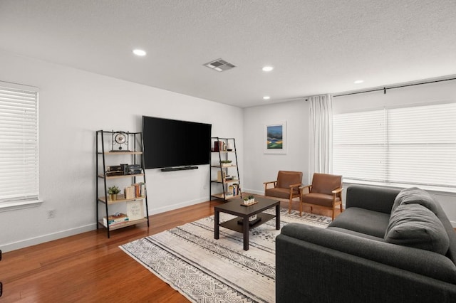 12305 Kelton Dr, Austin, TX 78754 - living area featuring wood finished floors, recessed lighting, and a textured ceiling