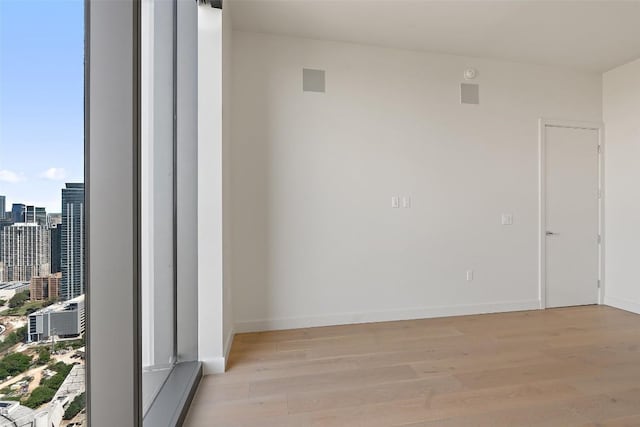 44 E Ave Unit 4302, Austin, TX 78701 - spare room with light wood-style floors and a view of city