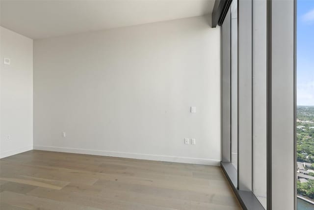 44 E Ave Unit 4302, Austin, TX 78701 - empty room featuring light wood-style floors and baseboards