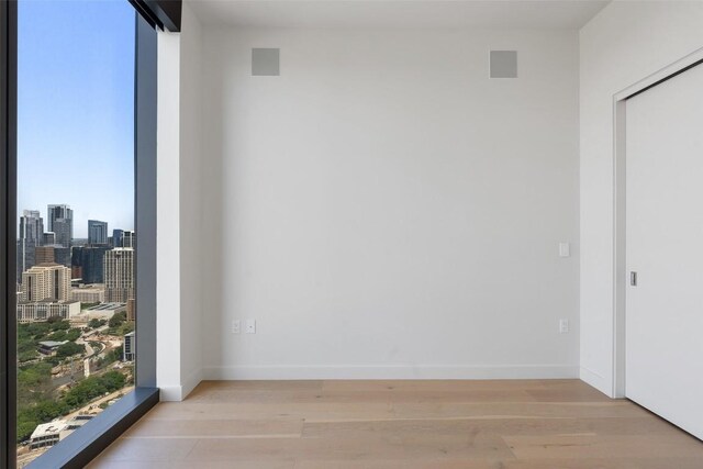 44 E Ave Unit 4302, Austin, TX 78701 - spare room featuring light wood-style floors and a skyline view